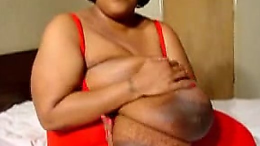 Gloria Stutters plays with her huge tits.